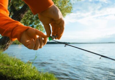Fishing on the lake. Fisherman hanging a bell on a fishing rod, close-up, selective focus. Special
